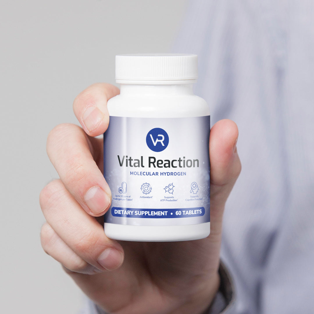 hand holding up bottle of vital reaction molecular hydrogen tablets
